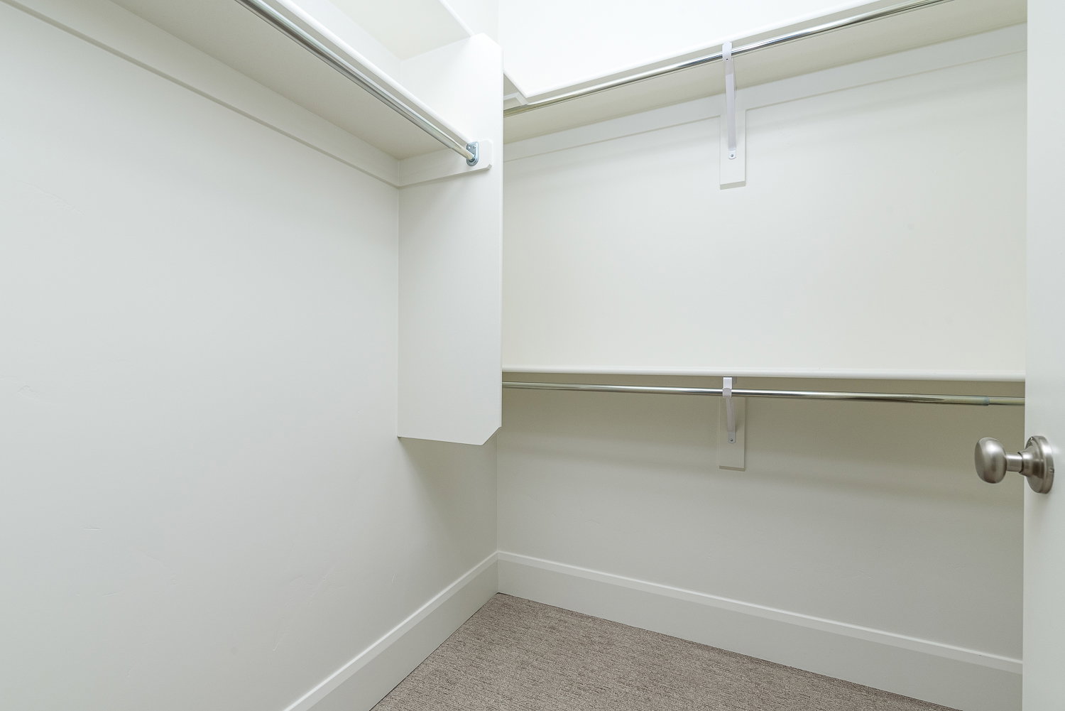 Walk in closet featuring light carpet