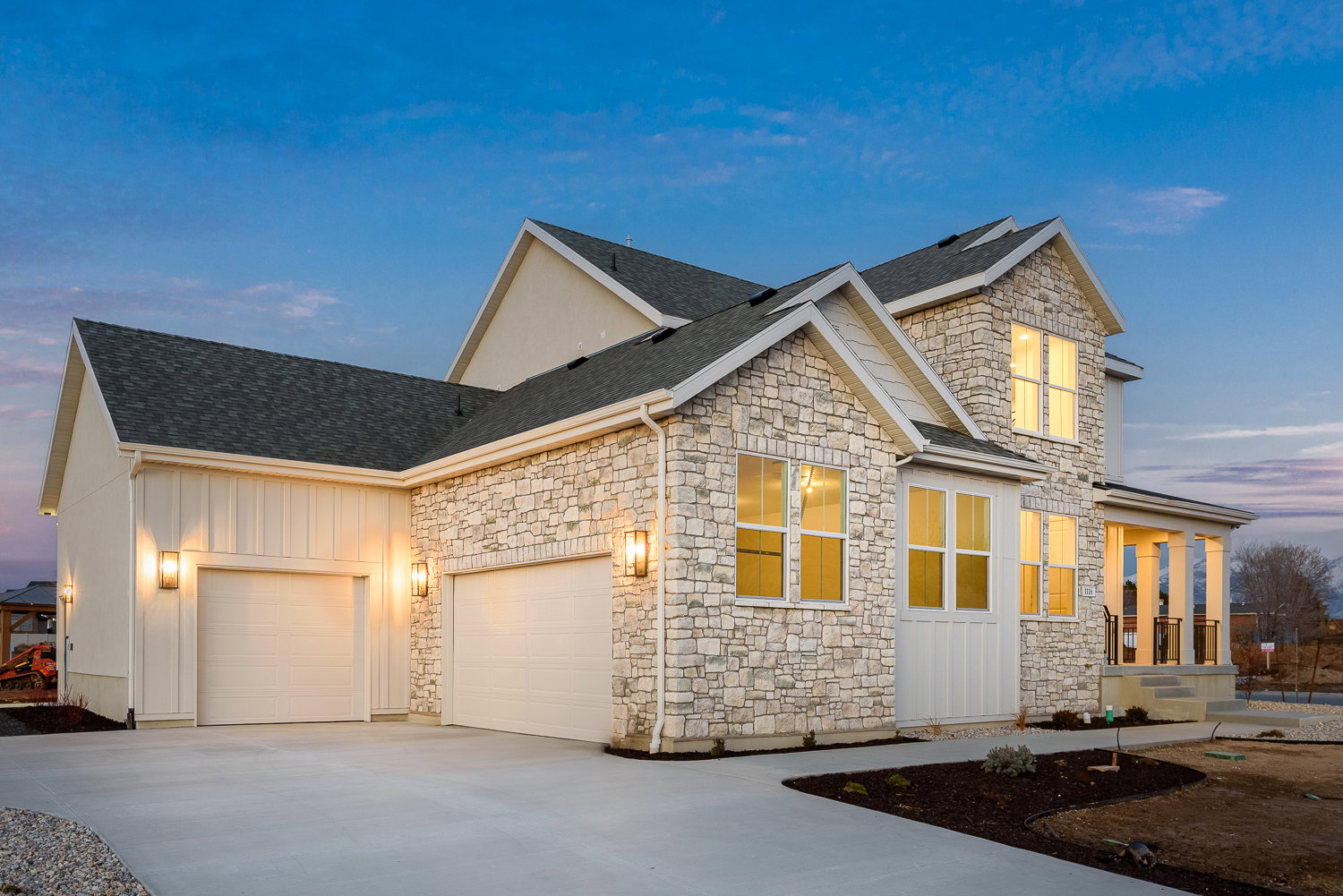 View of front of property with an attached garage, board and batten siding, and stone siding