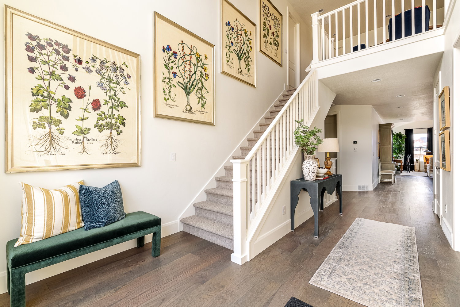 Staircase with hardwood / wood-style flooring and a high ceiling