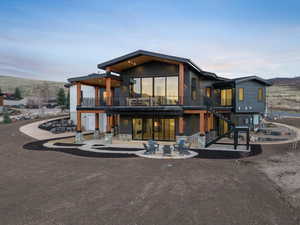 Back of property featuring a balcony and a patio