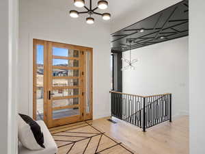 Entryway featuring hanging lights and wood finished floors