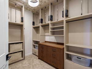 Walk in closet with light carpet