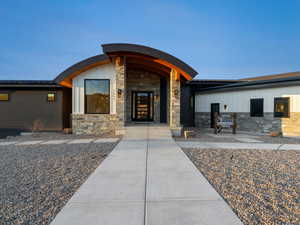 Entrance to property with stone siding and board and batten siding