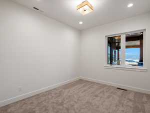 Spare room featuring carpet floors and recessed lighting
