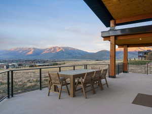 View of patio with outdoor dining area and a mountain view