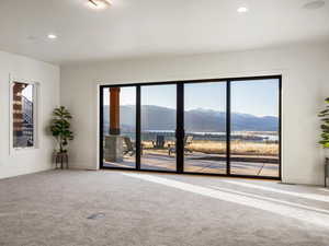 Spare room featuring a mountain view, carpet flooring, and recessed lighting