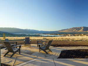 View of patio with a water and mountain view
