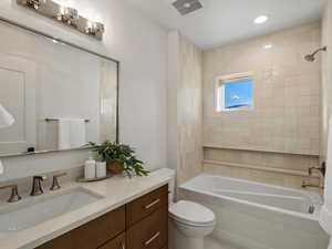 Bathroom featuring vanity and washtub / shower combination