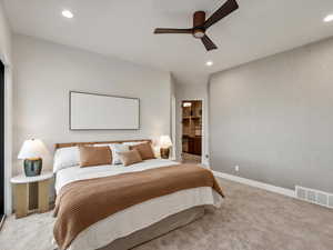Carpeted bedroom featuring recessed lighting, a ceiling fan, and a walk in closet