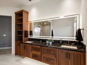 Bathroom with double vanity and a stall shower