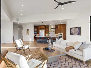 Living room featuring a ceiling fan, light wood-type flooring, and recessed lighting