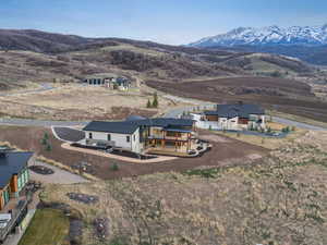 Aerial view of property and surrounding area with a mountainous background