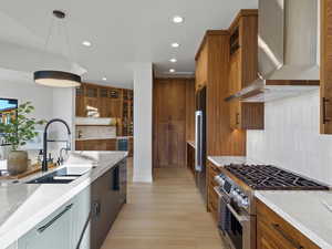 Kitchen with tasteful backsplash, stainless steel appliances, and light stone countertops