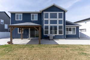 Back of house with a gazebo, a patio, stucco siding, and a standing seam roof