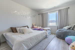 Bedroom featuring light wood-type flooring and baseboards