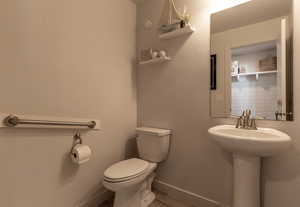 Bathroom with baseboards and light wood-style flooring