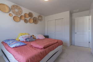 Bedroom with carpet and a closet