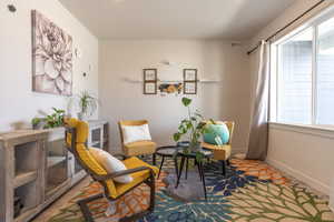 Living area featuring baseboards and wood finished floors