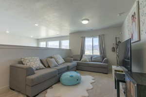 Living area with healthy amount of natural light and light carpet