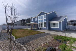 View of front facade with a gazebo, a fenced backyard, a patio area, and stucco siding