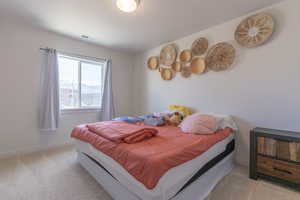 Bedroom with light colored carpet