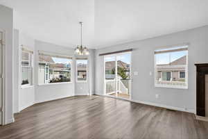 Unfurnished dining area with a chandelier and wood finished floors