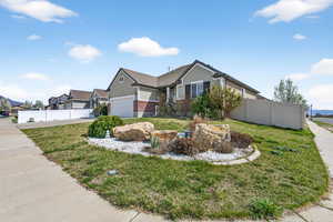 View of front of property featuring brick siding, driveway, and an attached garage