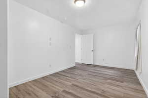 Unfurnished room with light wood-type flooring and a textured ceiling