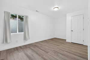 Unfurnished room featuring baseboards and light wood-style floors