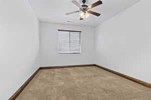 Unfurnished room with light carpet and a ceiling fan