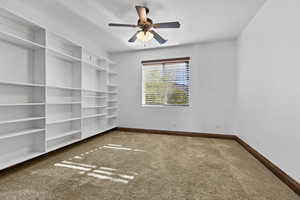 Empty room with carpet floors and ceiling fan