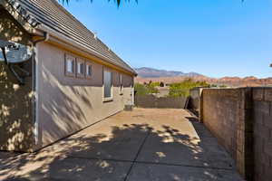 Fenced backyard featuring a mountain view