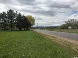 View of asphalt street with a view of rural / pastoral area