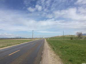 View of asphalt street with a rural view