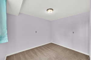 Unfurnished room featuring baseboards and carpet floors