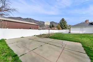 Fenced backyard with a patio area and a mountain view