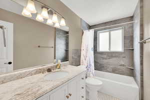 Full bath with vanity and shower / bath combo