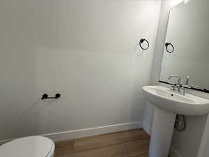 Bathroom featuring toilet and light wood-type flooring