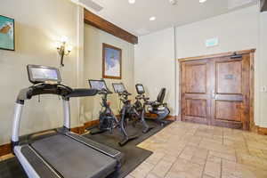 Workout room featuring recessed lighting