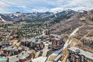 Aerial view of property and surrounding area with mountains