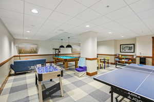 Rec room featuring recessed lighting, a paneled ceiling, billiards, and a wainscoted wall