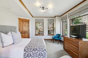 Bedroom with light colored carpet and crown molding