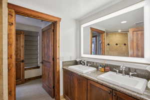 Bathroom featuring double vanity and light colored carpet