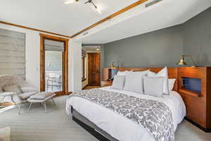 Bedroom with carpet floors, access to outside, and ornamental molding