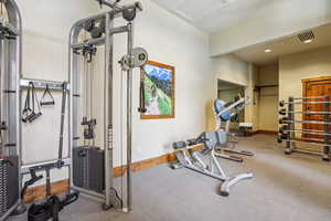 Exercise area featuring recessed lighting and attic access