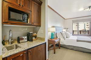 Bedroom with a sink and ornamental molding