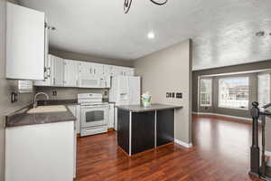 Functional kitchen with ample cabinet space, breakfast bar seating, and easy flow into the dining area—perfect for everyday living and entertaining.