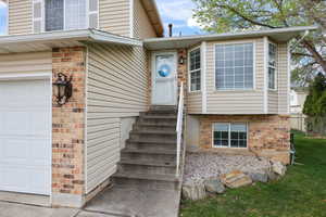 Property entrance with brick siding and a garage
