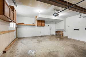 Additional view of the 2-car garage showcasing extended storage options, built-in shelving, and workspace potential. Ideal for projects, organization, and everyday convenience.