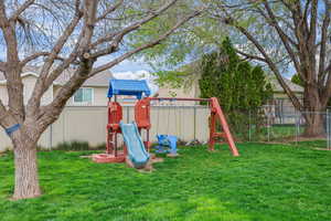 Built for memory-making—this shaded backyard play space is ready for everything from slow summer mornings to after-school adventures. Room to roam, climb, swing, and just be a kid.